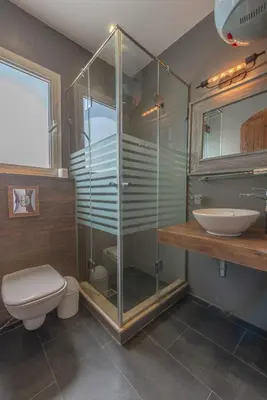 a bathroom with a shower and a toilet and a sink at Beautiful 4 BDR Villa With Private Pool in Hurghada
