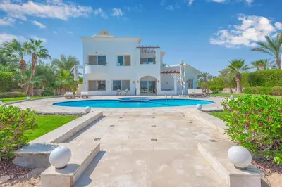 a large villa with a swimming pool and palm trees at Beautiful 4 BDR Villa With Private Pool in Hurghada