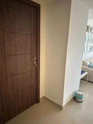 a wooden door in a room with a white wall at G cribs cozy 1bd apartment in El Gouna