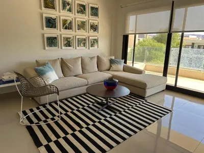a living room with a couch and a table at G cribs cozy 1bd apartment in El Gouna