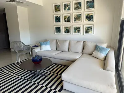 a living room with a white couch and a table at G cribs cozy 1bd apartment in El Gouna