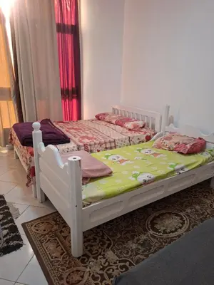 two twin beds in a room with at Desert pearl in Hurghada
