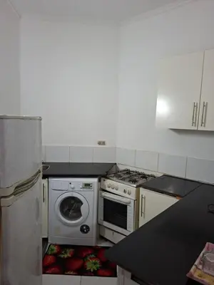 a kitchen with a stove and a washing machine at Desert pearl in Hurghada