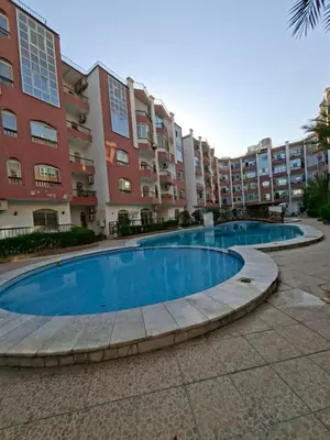 a large swimming pool in front of a building at Desert pearl in Hurghada