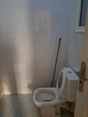 a bathroom with a toilet with the lid up at Lotos studio in Hurghada