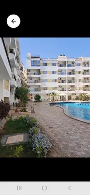 a view of a large apartment building with a swimming pool at Lotos studio in Hurghada