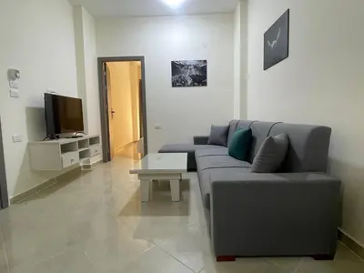 a living room with a couch and a tv at Bayt Hassan A13 - Superb 2 bedrooms in Hurghada