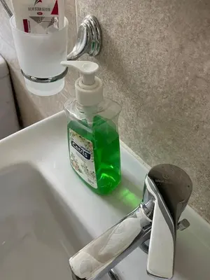 a bottle of soap sitting on top of a sink at Bayt Hassan A13 - Superb 2 bedrooms in Hurghada