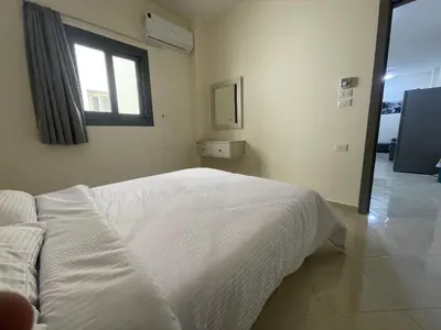 a bedroom with a white bed and a window at Bayt Hassan A13 - Superb 2 bedrooms in Hurghada