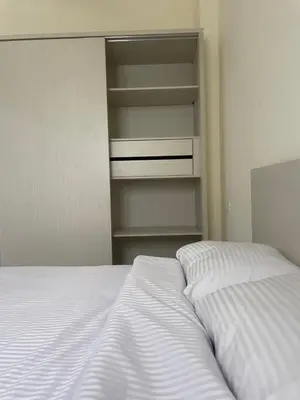 a bedroom with a bed and an empty closet at Bayt Hassan A13 - Superb 2 bedrooms in Hurghada