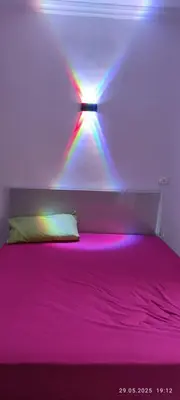a bedroom with a bed with neon lights on it at Fiesta resort in Hurghada