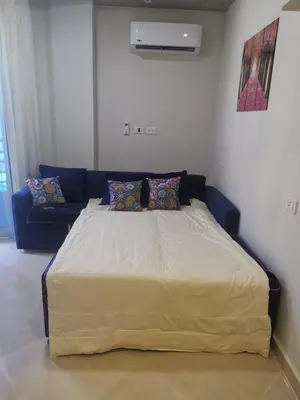 a large bed in a room with a couch at Princess Resort in Hurghada