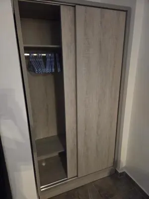 a wooden cabinet with a glass door at Aqua infinity in Hurghada