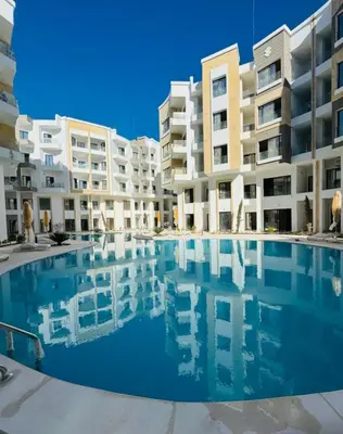 a swimming pool in front of some apartment buildings at Aqua infinity in Hurghada