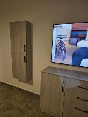 a bedroom with a flat screen tv and a bed at Aqua infinity in Hurghada