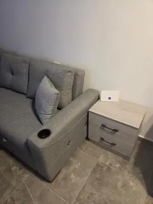 a couch with a side table with a laptop on it at Aqua infinity in Hurghada