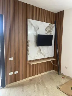 a flat screen tv on a wall in a room at شقة مبارك in Hurghada