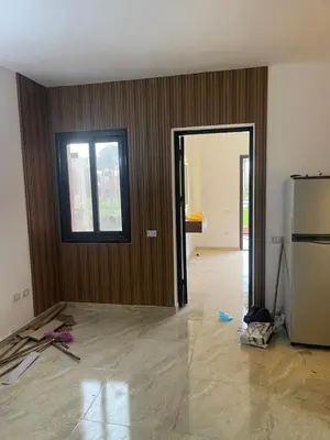 an empty room with a kitchen and a refrigerator at شقة مبارك in Hurghada