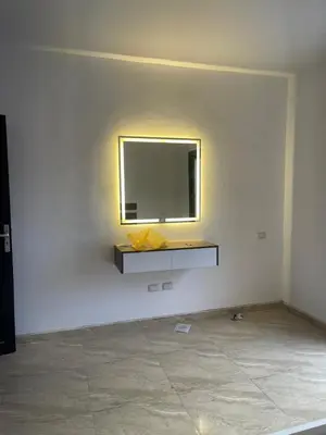a wall with a mirror and a shelf on a wall at شقة مبارك in Hurghada