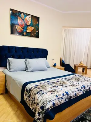 a bedroom with a bed with a blue head board at Hurghada Studios in Hurghada