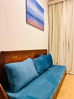 a blue pillow on a bed in a room at Hurghada Studios in Hurghada
