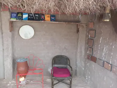 a chair and a vase sitting in a room at Soul House in Jazīrat Fīlah
