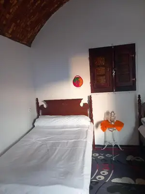 a bedroom with a bed and a small table at Soul House in Jazīrat Fīlah
