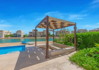 a pavilion next to a swimming pool in a resort at Breezy Lagoonfront Escape 3BR with Private Pool I Tawila El Gouna in Hurghada