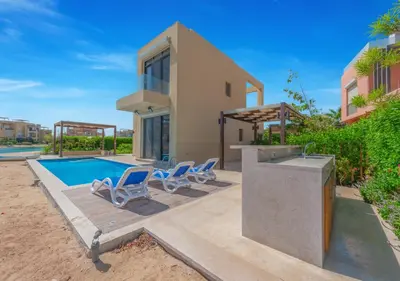 a villa with a swimming pool and a house at Breezy Lagoonfront Escape 3BR with Private Pool I Tawila El Gouna in Hurghada