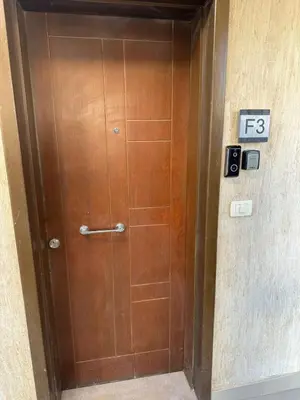 a wooden door in a building with a sign on it at Elgouna G cribs b-7 first floor in Hurghada