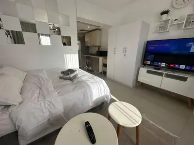 a bedroom with a large bed and a television at Elgouna g-cripes b-7 in Hurghada