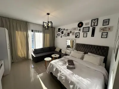 a bedroom with a large bed and a couch at Elgouna g-cripes b-7 in Hurghada