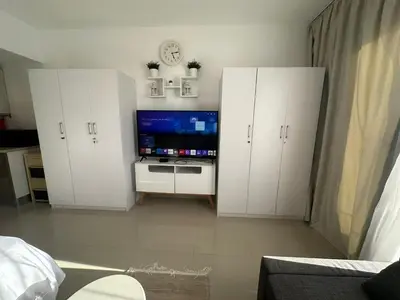 a living room with white cabinets and a flat screen tv at Elgouna g-cripes b-7 in Hurghada