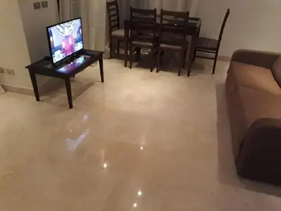 a living room with a couch and a television on a table at elgouna scarab es first floor in El Gouna