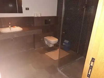 a bathroom with a toilet and a sink and a shower at elgouna scarab es first floor in El Gouna