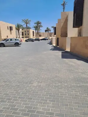 a parking lot with cars and palm trees at elgouna scarab es first floor in El Gouna