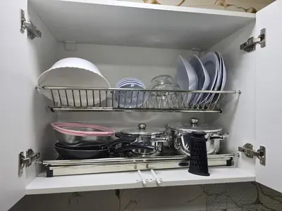 a shelf with dishes and pans in a pantry at Sheraton - New & Stylish Flat in Hurghada