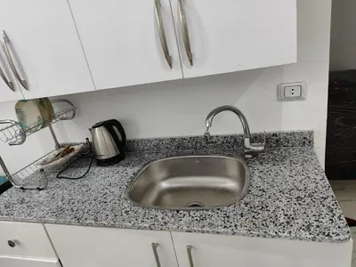 a kitchen counter with a stainless steel sink at Cozy Modern Apartament in Hurghada