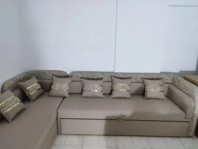 a couch with pillows on it in a living room at Cozy Modern Apartament in Hurghada