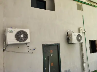 a building with a fan and a door with a window at Cozy Modern Apartament in Hurghada