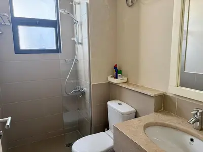 a bathroom with a shower and a toilet and a sink at Panoramic 2BR Apt-Free Pool And Lagoon Access At ElGouna in Hurghada