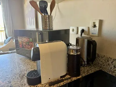 a kitchen counter top with a coffee maker and a coffee maker at Panoramic 2BR Apt-Free Pool And Lagoon Access At ElGouna in Hurghada