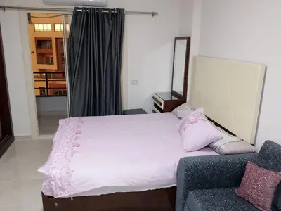 a bedroom with a large bed and a couch at Tiba Golden Resort Hurghada in Hurghada