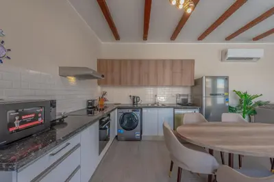 a kitchen with a table and a dining room at Luxury 2 Bedrooms in Bali - Elgouna with pool in Hurghada