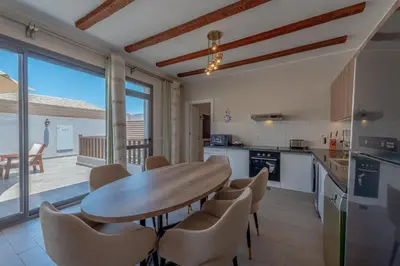 a kitchen with a wooden table and chairs at Luxury 2 Bedrooms in Bali - Elgouna with pool in Hurghada