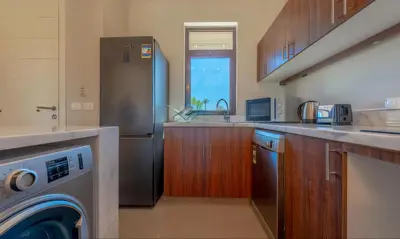 a kitchen with a stainless steel refrigerator and a dishwasher at Luxury Stays in Cyan El Gouna in Hurghada