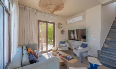 a living room with a blue couch and chairs at Luxury Stays in Cyan El Gouna in Hurghada
