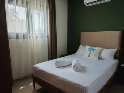 a bedroom with a bed with towels and a window at Villa Swenet in Aswan