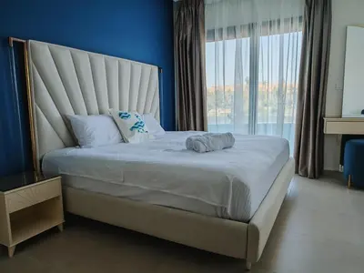 a bedroom with a large bed with a large window at Villa Swenet in Aswan