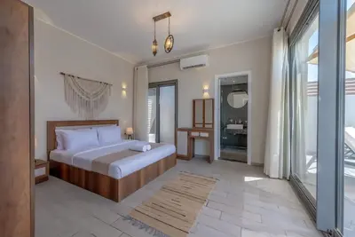 a bedroom with a bed and a large window at Luxury Stays in Bali El Gouna in Hurghada
